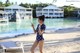 A woman in a polka dot swimsuit standing on a beach.