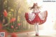 A woman in a red and white dress is walking down a road.