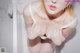 A woman in a white bra is taking a bath.