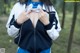 A woman in a blue and white jacket is posing for a picture.