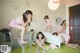 A group of young women sitting on top of a bed.