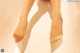 A close up of a woman's legs in high heels.